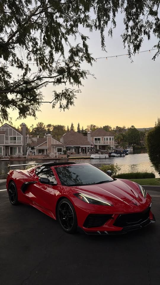 Red Corvette Stingray parked at golden hour