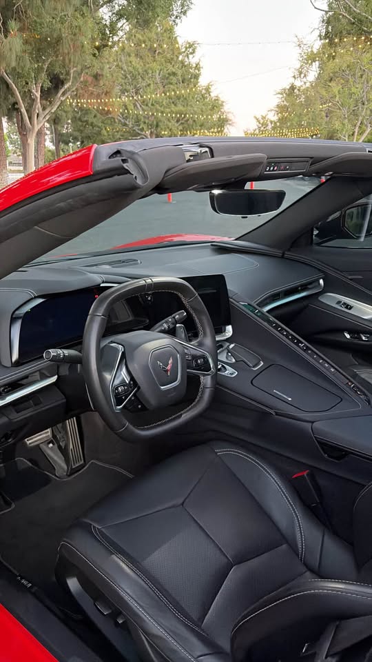 Driver cockpit of the red Corvette with squared steering wheel